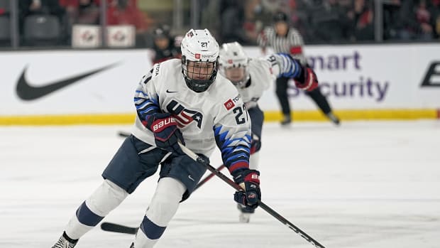 Nov 21, 2021; Kingston, Ontario, CAN; USA forward Britta Curl (27) tries to control a puck against Canada during the first period in a Rivalry Series women's hockey game at Leon's Centre. Mandatory Credit: John E. Sokolowski-USA TODAY Sports